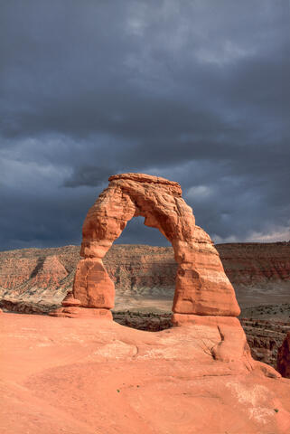 Dellicate arch with approaching storm clouds 