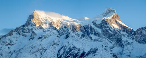 The rough, sharp, granite, windblown and snow-covered peaks of the paine massif are seen in torres del paine national park in chile in the winter