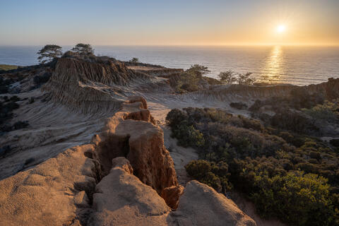 Torrey Pines bluffs overlooking the Pacific Ocean as the sun sets