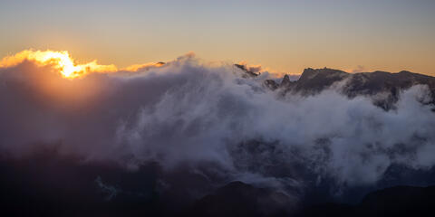 Sunrise viewed from Bica da Cana reminiscent of fire and smoke in the valleys with Pico do Arieiro and Pico Ruivo in view