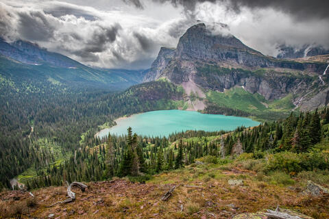 Grinnell lake as seen from the Grinnell lake trail in glacier national park in montana. Angel wing is seen in the background on this cloudy day.