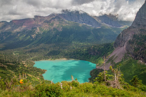 Grinnell lake as seen from the Grinnell lake trail in glacier national park in montana. Allen Mountain is seen in the background on this cloudy day.
