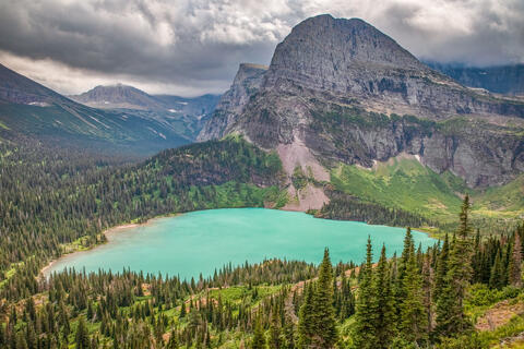 Grinnell lake as seen from the Grinnell lake trail in glacier national park in montana. Angel wing is seen in the background on this cloudy day.