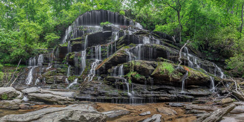 Panoramic view of the gentle cascades of yellow branch falls in Oconee, SC, USA in the spring with good flow of water. 