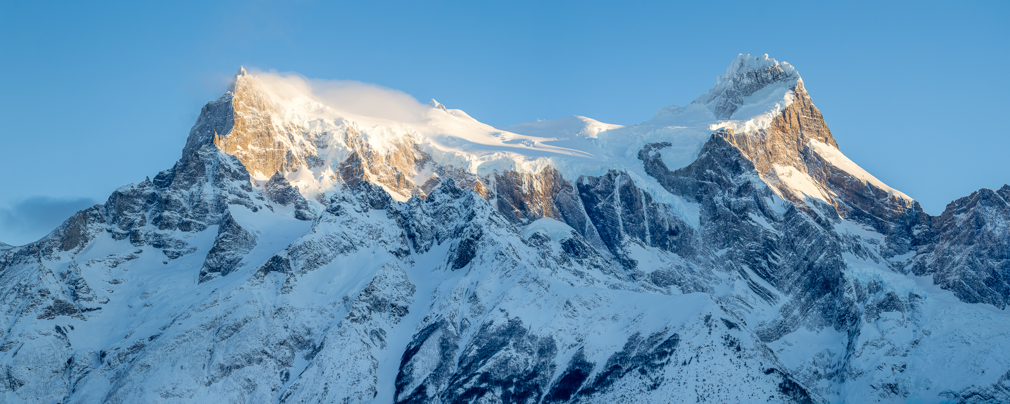 Patagonian Winter The rough, sharp, granite, windblown and snow-covered peaks of the paine massif are seen in torres del paine national park in chile in the winter
